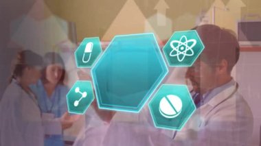 Animation of medical icons over caucasian male doctor looking at x ray photo. global covid 19 pandemic, medicine and health concept digitally generated video.