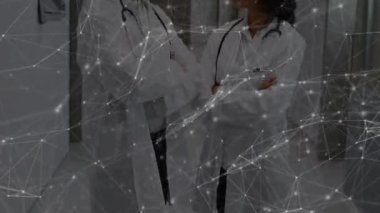 Animation of network of connections over two diverse doctors. Global medicine, technology, data processing and digital interface concept digitally generated video.