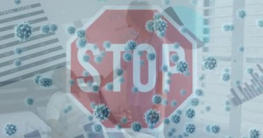 Animation of covid 19 cells over stop sing and data procesing. Global covid 19 pandemic, science and connections concept digitally generated video.