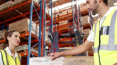 Animation of falling hearts over diverse group of warehouse workers. Global shipping, delivery, business, data processing and technology concept digitally generated video.