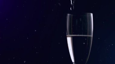 Animation of falling confetti over glass of champagne on dark background. new years eve party and celebration concept digitally generated video.
