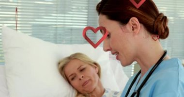 Kafkas erkek doktor ve beyaz kadın hasta üzerine düşen kalp ikonlarının canlandırılması. dünya kalp günü dijital olarak oluşturulan video.