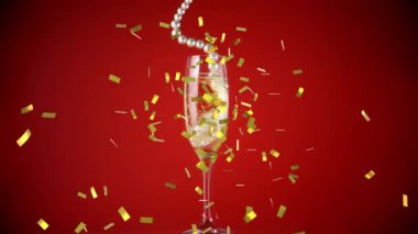 Animation of falling confetti over glass of champagne on red background. new years eve party and celebration concept digitally generated video.