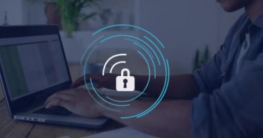 Animation of padlock icon over caucasian businessman using laptop in office. Global business and digital interface concept digitally generated video.