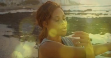 Mixed race woman doing exercises outdoors 