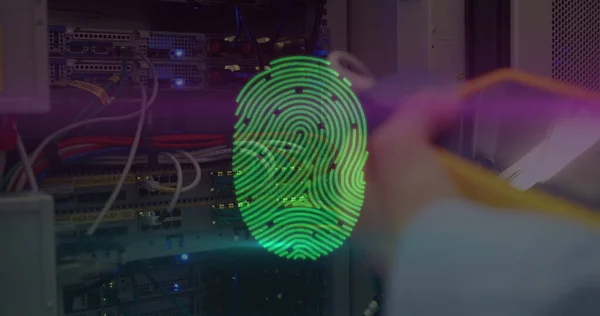 Image of digital interface with biometric fingerprint being scanned over man checking computer server in the background. Global digital online security concept digitally generated image.