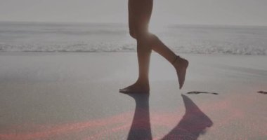 Kumsalda yürüyen beyaz kadının üzerindeki ışık lekelerinin canlandırması. Tatiller ve dijital arayüz kavramı dijital olarak oluşturulmuş video.