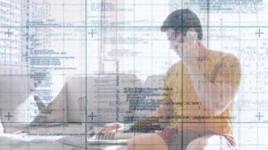 Animation of data processing over caucasian man working from home with laptop and smartphone. Home office and working with technology concept digitally generated video.