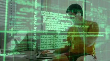 Animation of data processing over caucasian man working from home with laptop and smartphone. Home office and working with technology concept digitally generated video.