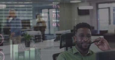 Animation of data processing over african american businessman in office. Global business and digital interface concept digitally generated video.