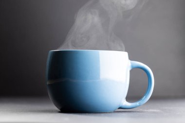 Image of blue cup of hot black coffee on black background. Coffee, refreshment and beverages.