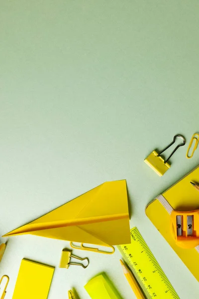 Vertical Composition Yellow School Equipment Paper Plane Green Surface Copy — Stock Photo, Image