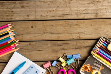 Composition of diverse school tools on wooden surface. School equipment, tools, learning and education concept.