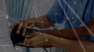Animation of network of connections over hands of diverse male doctor and patient. Health, medicine, connections and technology concept digitally generated video.