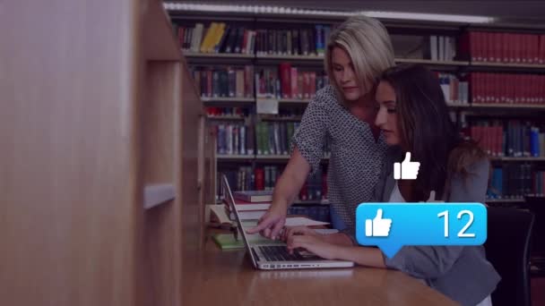 Animation Falling Social Media Icons Two Caucasian Students Using Laptop — Stockvideo