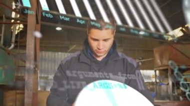 Animation of data processing and graph over biracial man in workshop. Global business, computing and digital interface concept digitally generated video.