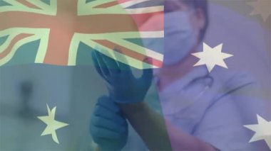 Animation of flag of australia over african american female doctor wearing face mask. Global medicine, healthcare and digital interface concept digitally generated video.