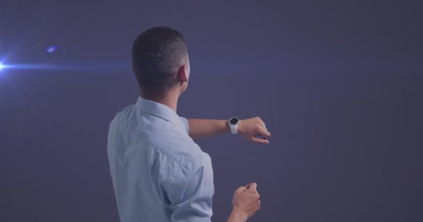 Animation Caucasian Businessman Using Smartwatch Glowing Light Blue Background Global — Stockvideo