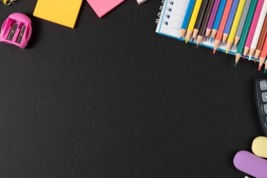 Çeşitli ofis malzemelerini, çivileri, cetvelleri, makasları ve siyah arka planda hesap makinelerini hayal edin. Eğitim, öğrenme ve yaratıcılık.