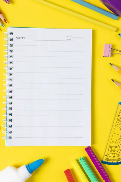 Imagine Various Office Supplies Plastic Utensils Notebook Crayons Yellow Background — Stok fotoğraf