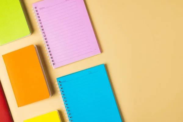 Composition Colorful Notebooks Lying Yellow Surface Copy Space School Equipment —  Fotos de Stock