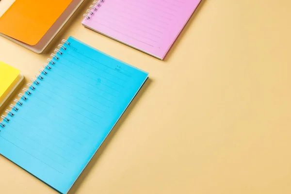 Composition Colorful Notebooks Lying Yellow Surface Copy Space School Equipment — Fotografia de Stock
