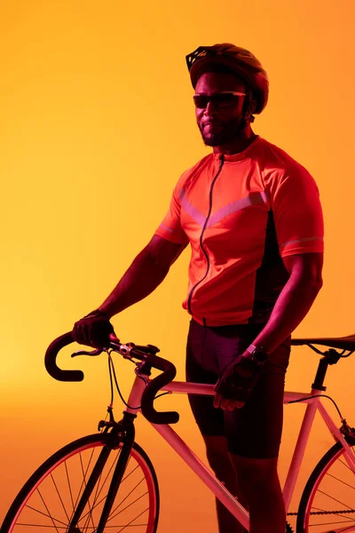 Vertical Image African American Male Cyclist Looking Camera Yellow Lighting — Φωτογραφία Αρχείου