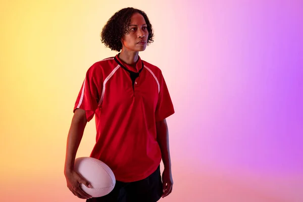 African American Female Rugby Player Rugby Ball Neon Pink Lighting — Stockfoto