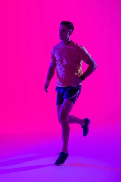 Caucasian Male Tennis Player Running Neon Pink Lighting Sport Movement — Photo