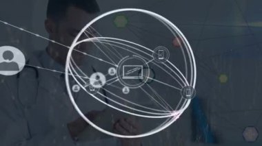 Animation of network of connections with icons over caucasian male doctor with stethoscope. Global medicine and digital interface concept digitally generated video.