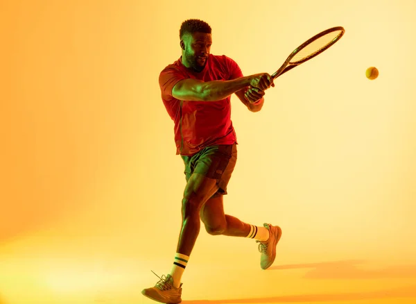 Image African American Male Tennis Player Hitting Ball Yellow Lighting — Stockfoto