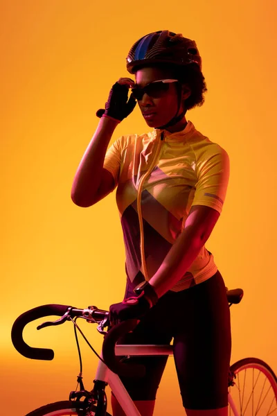 Vertical Image African American Female Cyclist Bike Neon Orange Lighting — ストック写真