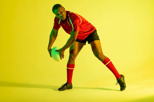 African American Male Rugby Player Rugby Ball Yellow Lighting Sport — Photo