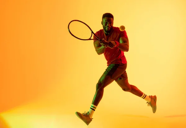 Image African American Male Tennis Player Hitting Ball Yellow Lighting — Stockfoto