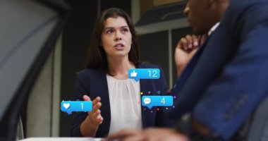 Animation of media icons over diverse business people in office. Global business and digital interface concept digitally generated video.