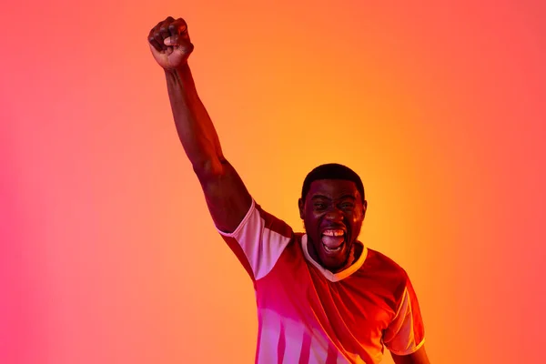 Portrait Happy African American Male Soccer Player Raising Hand Neon — Stockfoto