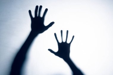 Composition of shape of two black hands on white background. Halloween tradition and celebration concept.