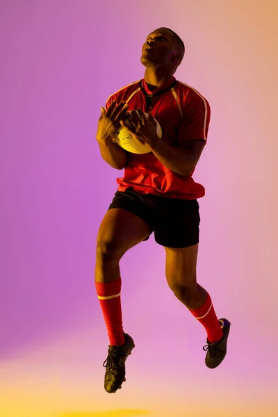 African American Male Rugby Player Rugby Ball Pink Lighting Sport — Fotografia de Stock