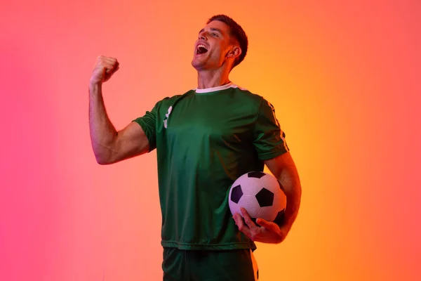 Happy Caucasian Male Soccer Player Raising Hand Football Neon Pink — 스톡 사진