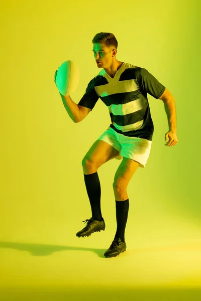 Caucasian Male Rugby Player Rugby Ball Yellow Lighting Sport Movement — 스톡 사진