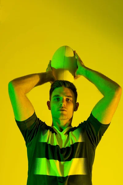 Portrait Caucasian Male Rugby Player Rugby Ball Yellow Lighting Sport — Stockfoto