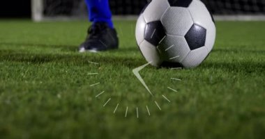 Animation of clock over legs of male soccer player with ball. Sport, training, math and time concept digitally generated video.