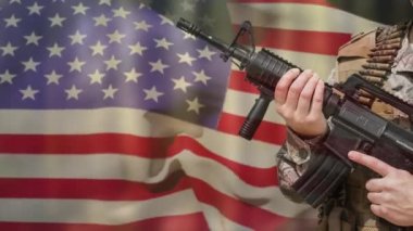 Animation of hands of soldier holding assault rifle over waving american flag. American patriotism, independence and armed forces concept digitally generated video.