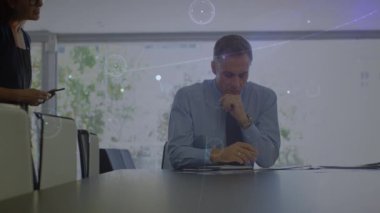 Animation of connections over caucasian boss and female worker at office. Network, connections, business and technology concept digitally generated video.