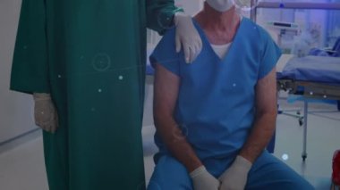 Animation of network of connections over caucasian female and male surgeons in face masks. Network, connections, health and medicine concept digitally generated video.