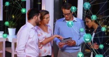 Animation of network of connections with icons over diverse businesspeople in office. global network, connections, business and technology concept digitally generated video.