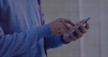 Statistical data processing against mid section of a man using smartphone. Global networking and business technology concept
