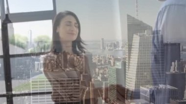 Animation of happy caucasian businesswoman and businessman shaking hands over cityscape. global business and communication concept digitally generated video.