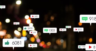 Animation of social media icons and numbers over out of focus city lights. global social media, networking, connections and digital interface concept digitally generated video.