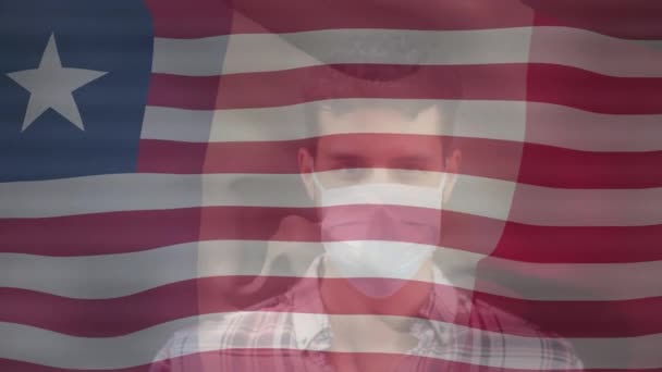 Animation Flag Liberia Biracial Man Face Mask Health Covid Pandemic — Αρχείο Βίντεο